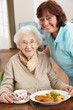 © Monkey Business - Senior Woman Being Served Meal By Carer