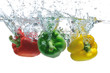 Three peppers falling in water