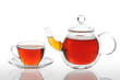 Teapot and cup with black tea on a white background