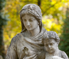 Monument Of The Woman With The Child On A Cemetery