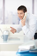 Canvas Print - Young businessman on phone smiling