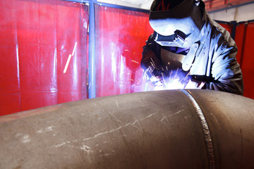 Wall Mural - worker weld metal in factory and sparks