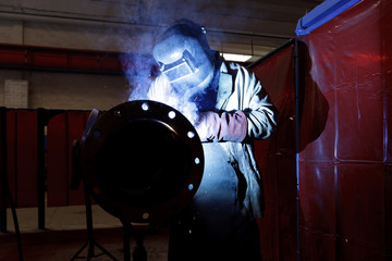 Wall Mural - worker weld metal in factory and sparks