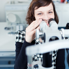 optometry concept - portrait of a young pretty optometrist using