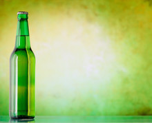 A Bottle Of Beer On A Green Background