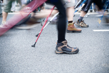 people on nordic walking race in city
