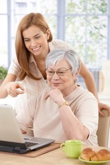 Wall Mural - Mother and adult daughter having fun smiling