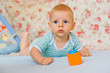 © mbt_studio - baby playing on blanket