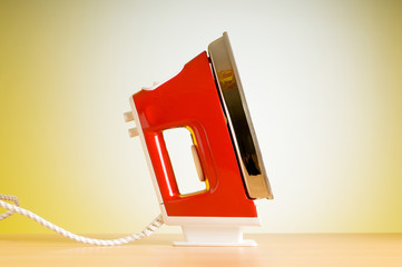 Poster - Modern electric iron against the colorful background