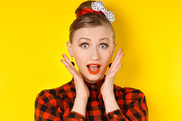 Close-up of a young woman looking excited against yellow backgro