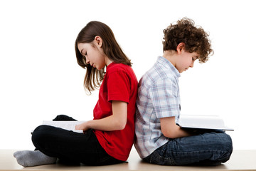 Girl and boy reading book isolated on white background