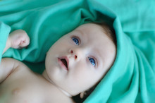 Little Baby On Turquoise Blanket