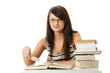 © Piotr Marcinski - Young student woman with lots of books studing.