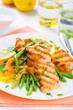 grilled salmon with spring asparagus on white plate, soft focus