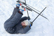 © Pavel Losevsky - Young boy with cross-country skis and poles lying on snow
