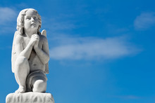 Praying Angel With A Blue Sky Background