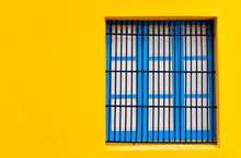 Blue Window On A Bright Yellow Wall