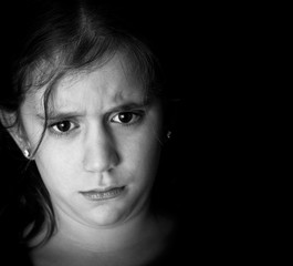 Wall Mural - Monochromatic image of a sad girl on a black background