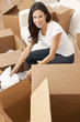 © Darren Baker - Single Woman Unpacking Boxes Moving House