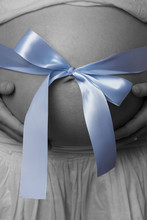 Pregnant Belly With Blue Ribbon
