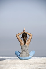 Sticker - Beautiful young woman with arms open, relaxing on the beach