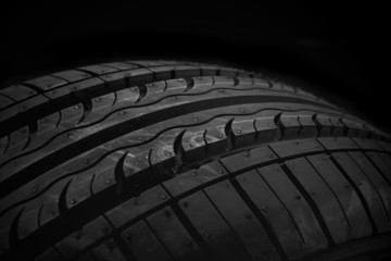  Car tire on black background