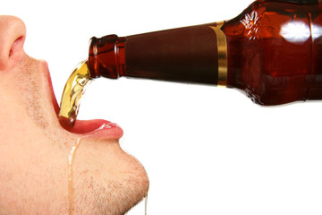 Wall Mural - beer is being poured into the mouth from bottle