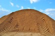 trace of a bulldozer on a mountain of sand