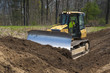 © Christian Delbert - Bulldozer pushing dirt on construction site