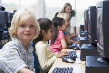 Wall Mural - Kindergarten children learning how to use computers.