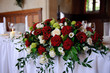Red roses decorate wedding table