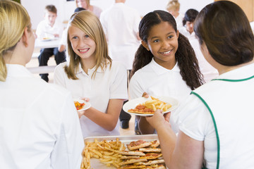 Wall Mural - Lunchladies serving plates of lunch in school cafeteria