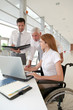 © goodluz - Handicapped woman attending a meeting in office
