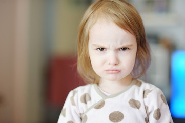 Portrait of little angry toddler girl