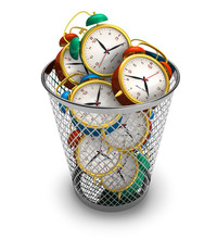 Wasting Time Concept: Alarm Clocks In The Trash Bin