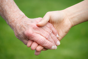 Senior and Young Women Holding Hands