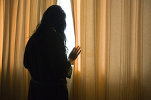 Depressed Woman By Window