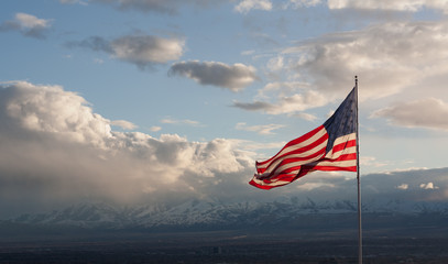 American Flag with clouds and mountains