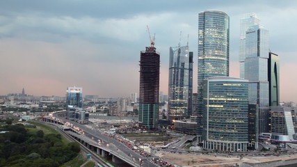 Wall Mural - Cars on road near modern building at evening