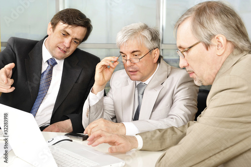 Fotografie, Obraz Portrait of three businessmen at the computer.