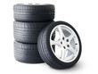 Isolated set of low profile summer tyres with one wheel in front