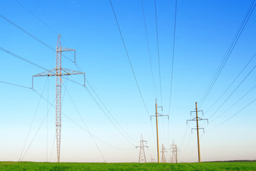 Row of power lines against a blue sky.