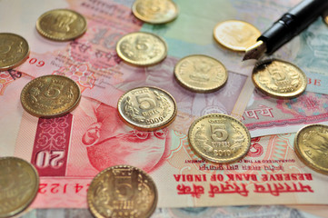 Indian Currency notes and Coins with fountain pen