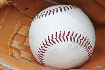 Wall Mural - Close up of baseball in catcher's mittt with shallow depth of fi