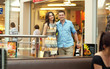 © konradbak - Young handsome couple having fun at shopping center