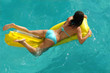 © snpolus - Young woman swimming on mattress in water pool