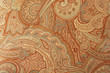 A brown paisley 70s style design pattern