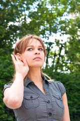 hand-ear listening young woman