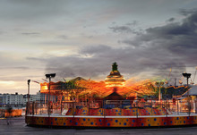 Fun Fair Carnival Ride Landscape With Moving Bright Lights