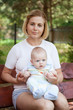 © Rafal Olechowski - Mother with baby boy sitting on bench outdoors